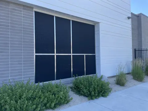 After: solar screens on a large commercial window