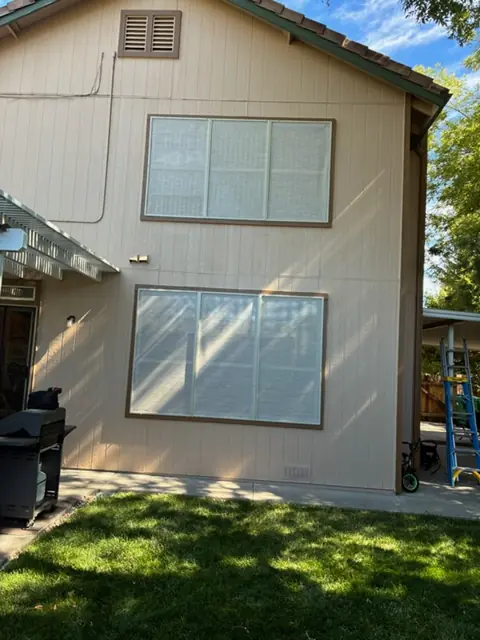 After: Rear windows of a two-story home, solar screens