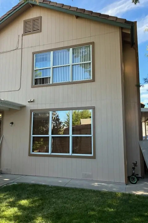 Before: The same two-story home from the patio corner, solar screens