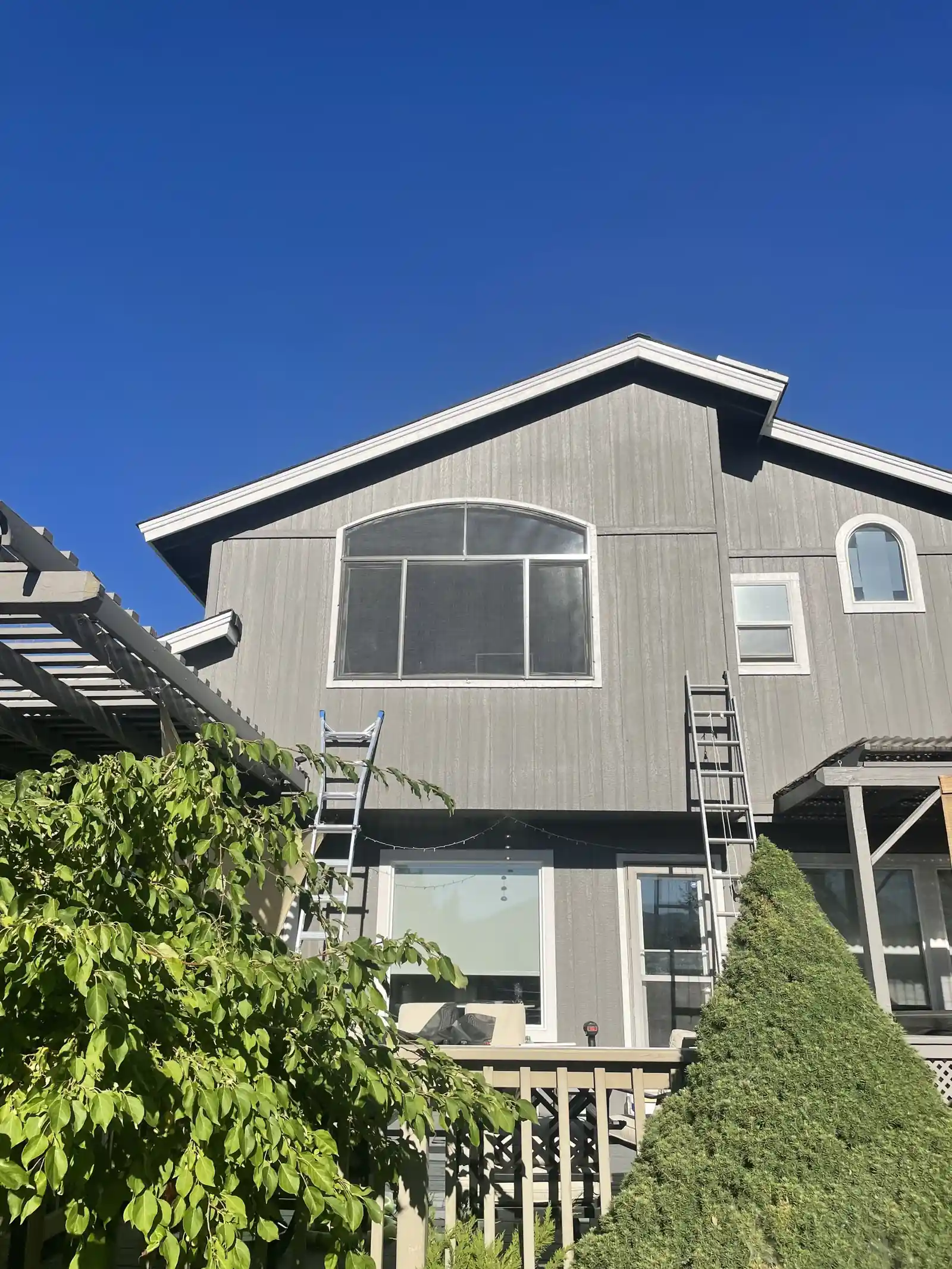 After: solar screens installed on upper-story and arched windows